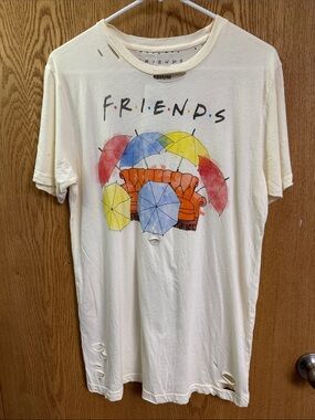 FRIENDS Cream Graphic Tee with Orange Couch and Colorful Umbrellas